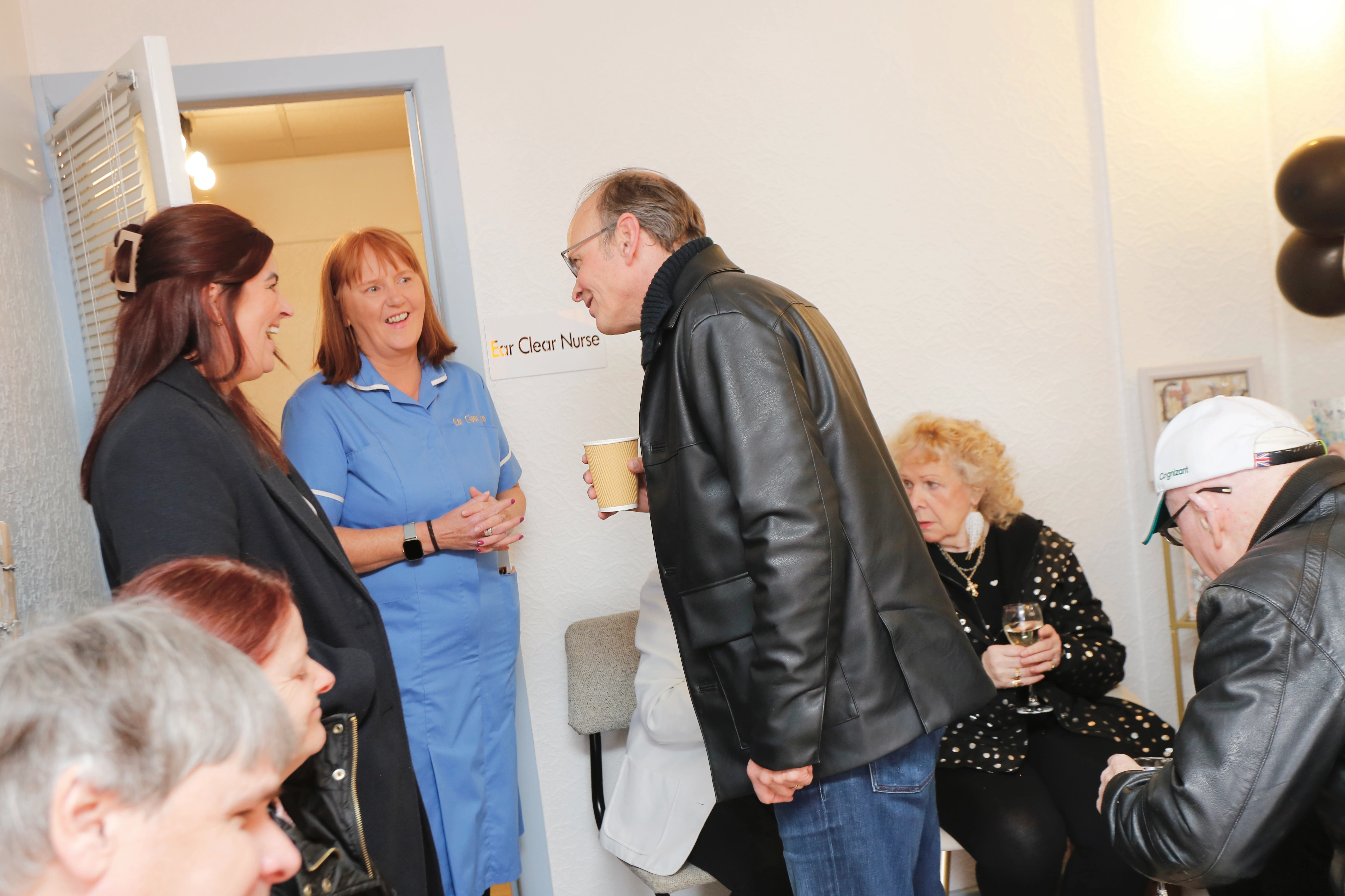 Warm conversation with guests inside the clinic during the open day